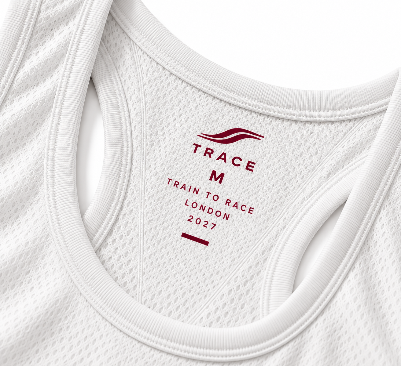 Close-up of the white tank's mesh neckline and updated TRACE label