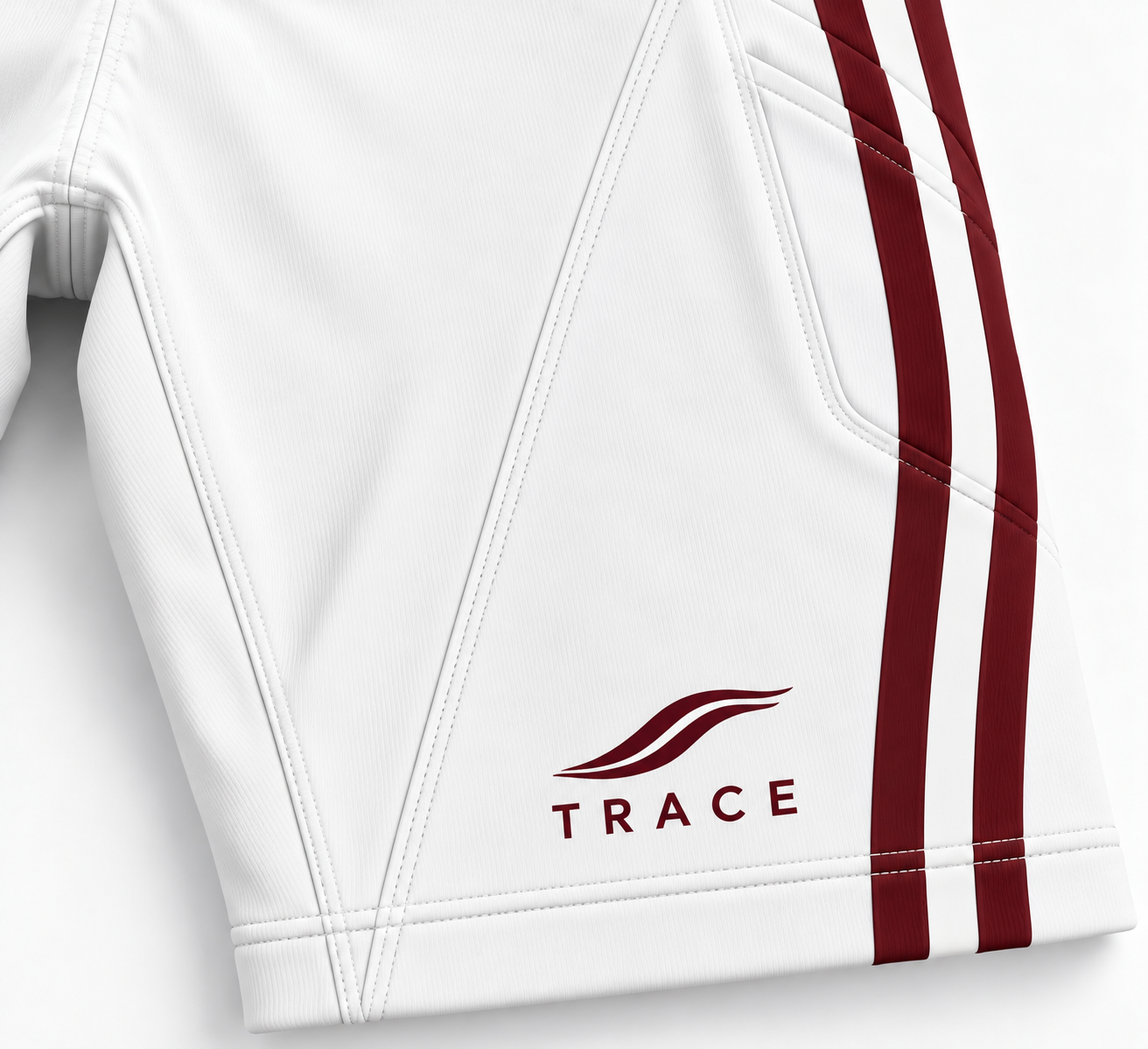 Close-up of the TRACE logo in burgundy on the white tights